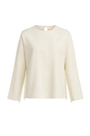 Ivory white long-sleeve top with fringe details from Stolen Stores, featuring a stylish and boho-chic design.