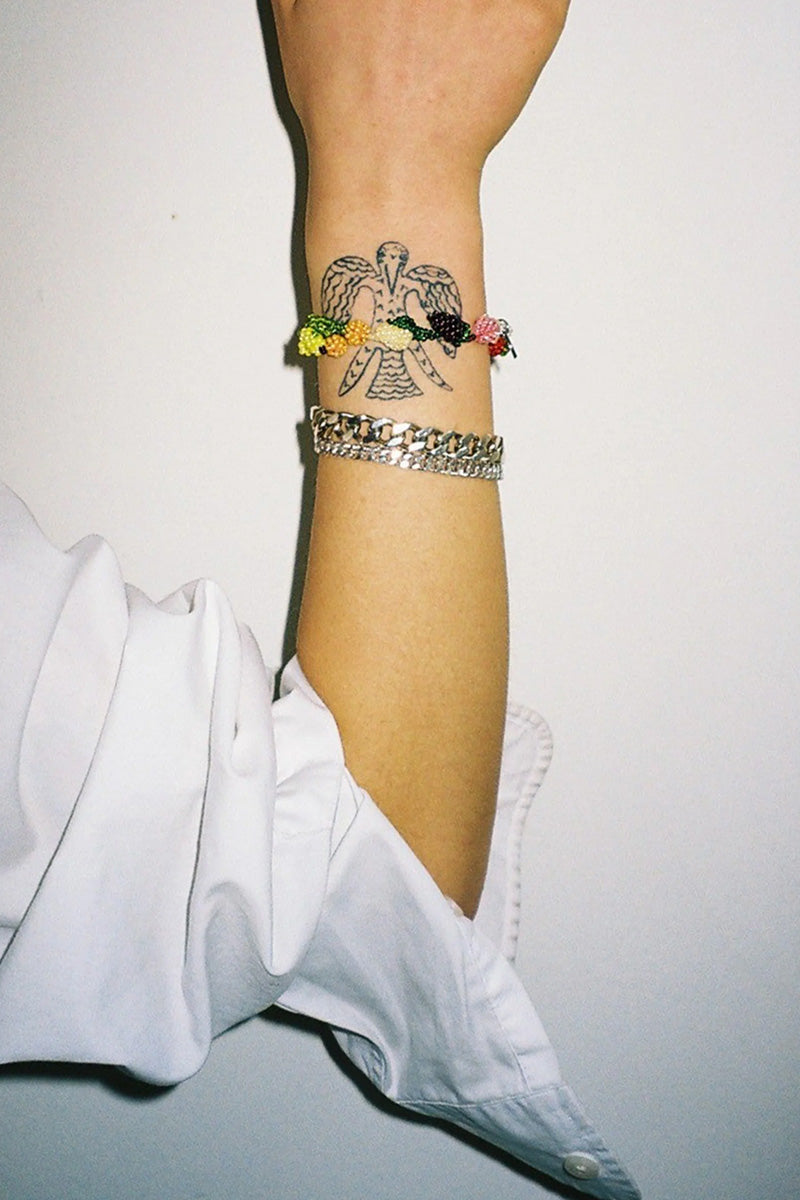 Colorful fruit salad-themed bracelet by Pura Utz featuring vibrant fruit charms and playful design.