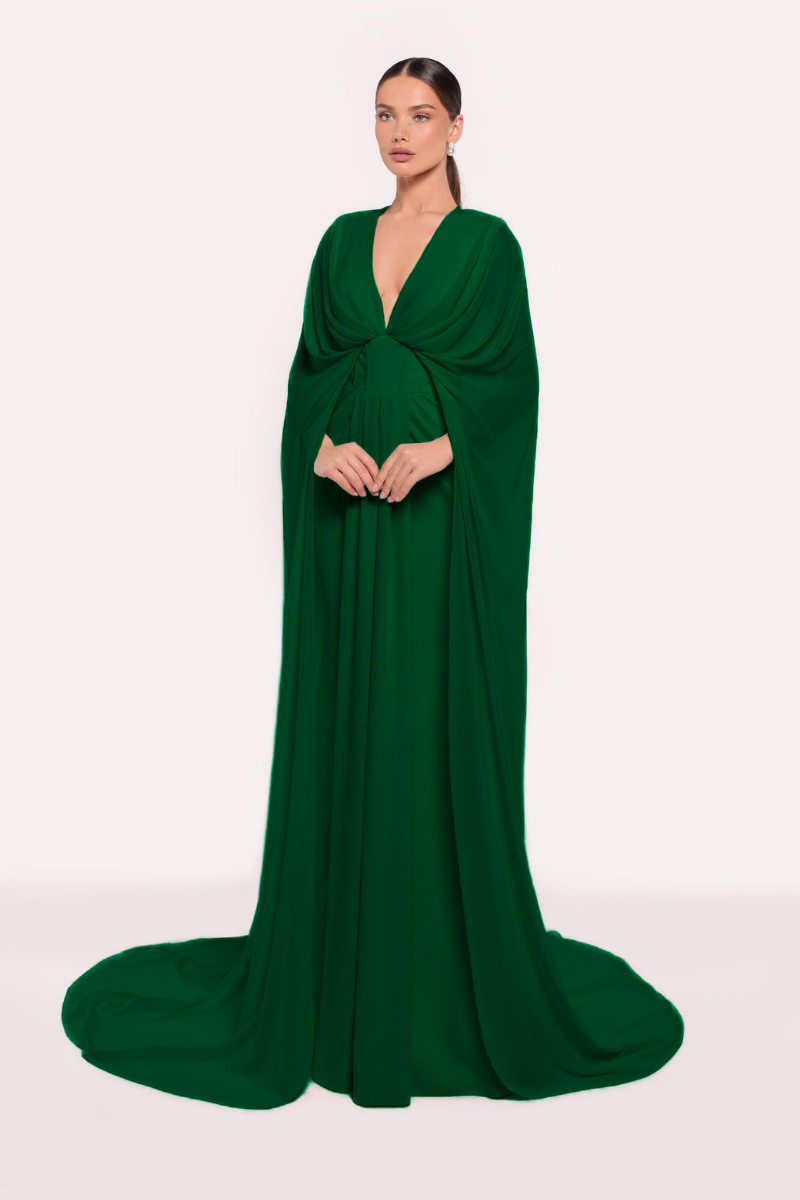 Emerald green gown by Tarık Ediz with elegant design, featuring flowing fabric and intricate details, perfect for formal occasions.