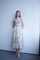 AISA Gardenia floral midi dress displayed on a hanger, showcasing its vibrant floral pattern and elegant midi length.