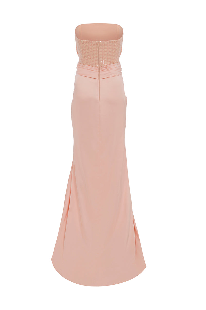 Light salmon YUNA gown by MOON / HAKAAN YILDIRIM displayed on ghostback mannequin, showcasing elegant fabric and flowing design.