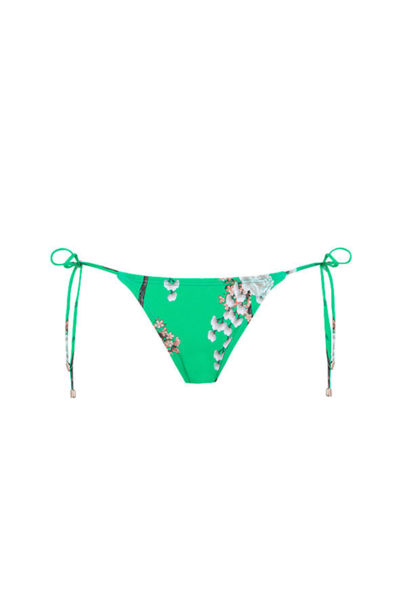 Aguaclara Jade side tie bikini bottoms displayed on a model, featuring a vibrant jade green color and adjustable side ties.
