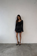Black Gigi dress by Junie, stylish mini dress with fitted silhouette and sleeveless design, perfect for casual or evening wear.