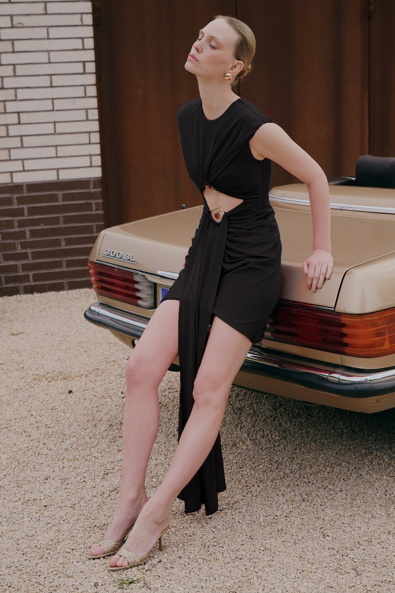 Black ELIOTH mini dress by Gigii's, stylish sleeveless design with a fitted silhouette, shown on a model.