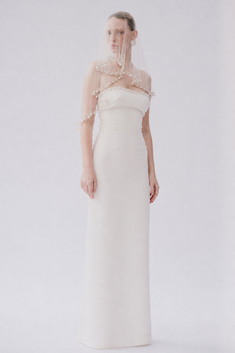 White Lotte veil hair accessory by Gigii's, featuring delicate fabric and intricate detailing for elegant styling.