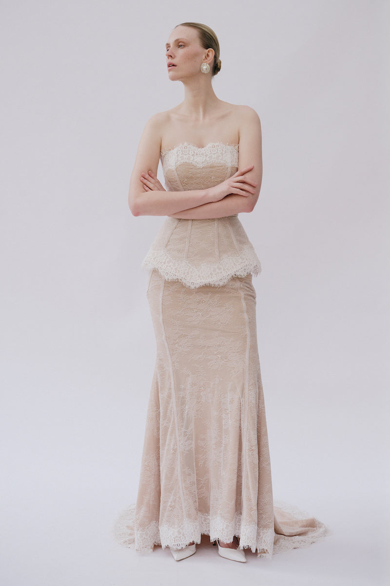 Elegant lace gown named Sabrina Dress by Gigii's, featuring intricate lace details and a flowing silhouette.