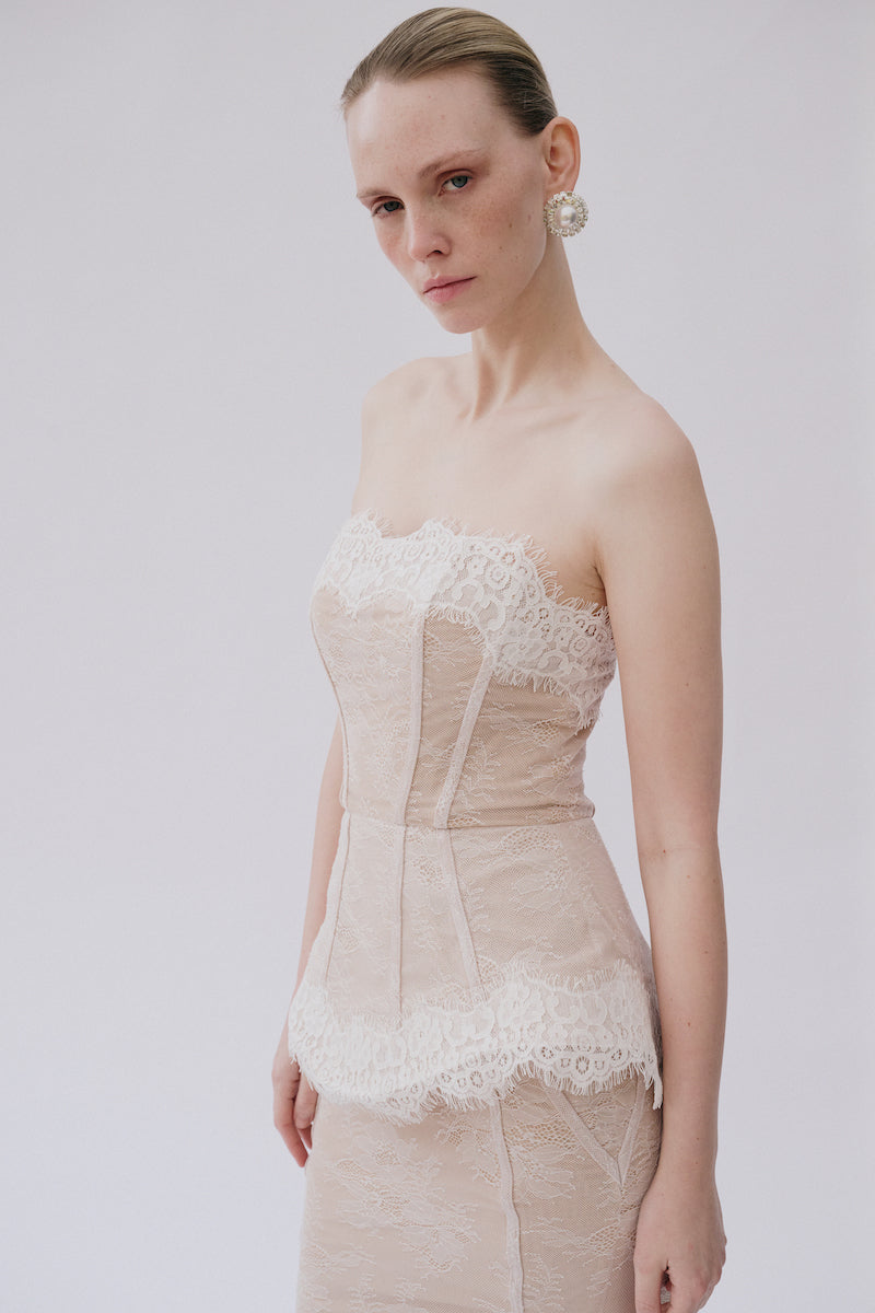 Elegant lace Sabrina gown by Gigii's featuring intricate lace details and a flowing silhouette.
