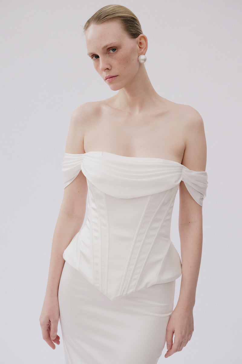 White Valentina co-ord top and skirt set by Gigii's, featuring a stylish matching crop top and high-waisted skirt.