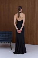 Black GISEL halter neck long evening gown by UNDRESS, featuring elegant drape and fitted silhouette for formal occasions.
