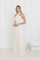 Elegant off-shoulder cream maxi evening dress by UNDRESS featuring flowing fabric and a fitted bodice for formal occasions.