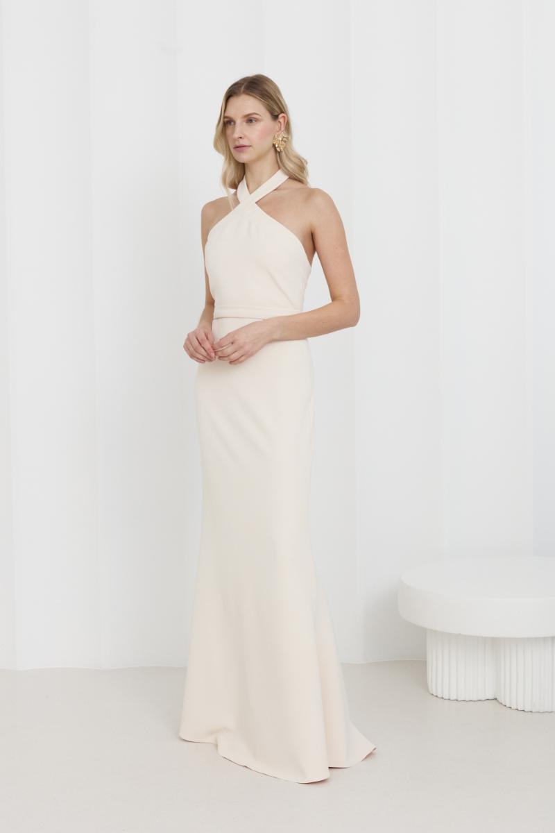Elegant off-shoulder cream maxi evening dress by UNDRESS featuring flowing fabric and a fitted bodice for formal occasions.