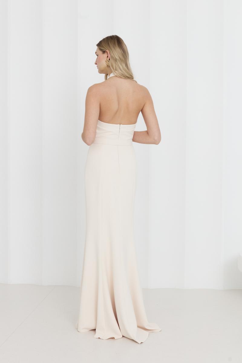 Elegant off-shoulder cream maxi evening dress by UNDRESS, flowing fabric with long, graceful silhouette suitable for formal occasions.