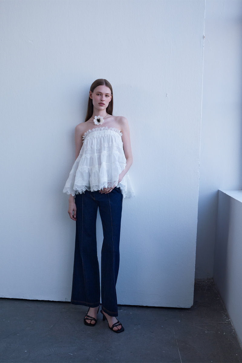 White AISA Grace Top, stylish women's blouse with a relaxed fit and elegant design, shown on a model.
