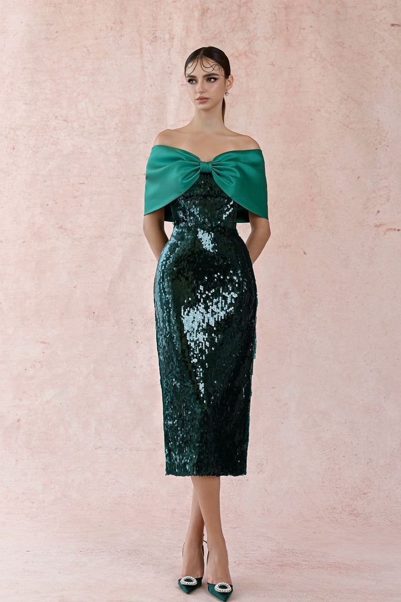 Green big bowtie gown by HACCHIC COUTURE featuring a flowing silhouette and elegant bow detail at the waist.