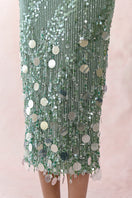 Green sequin strapless gown by HACCHIC COUTURE, featuring a flowing design and elegant strapless neckline.