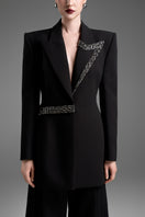 Black tailored blazer vest with asymmetrical side-tie belt by GVLUX, showing sleek fit and stylish design.