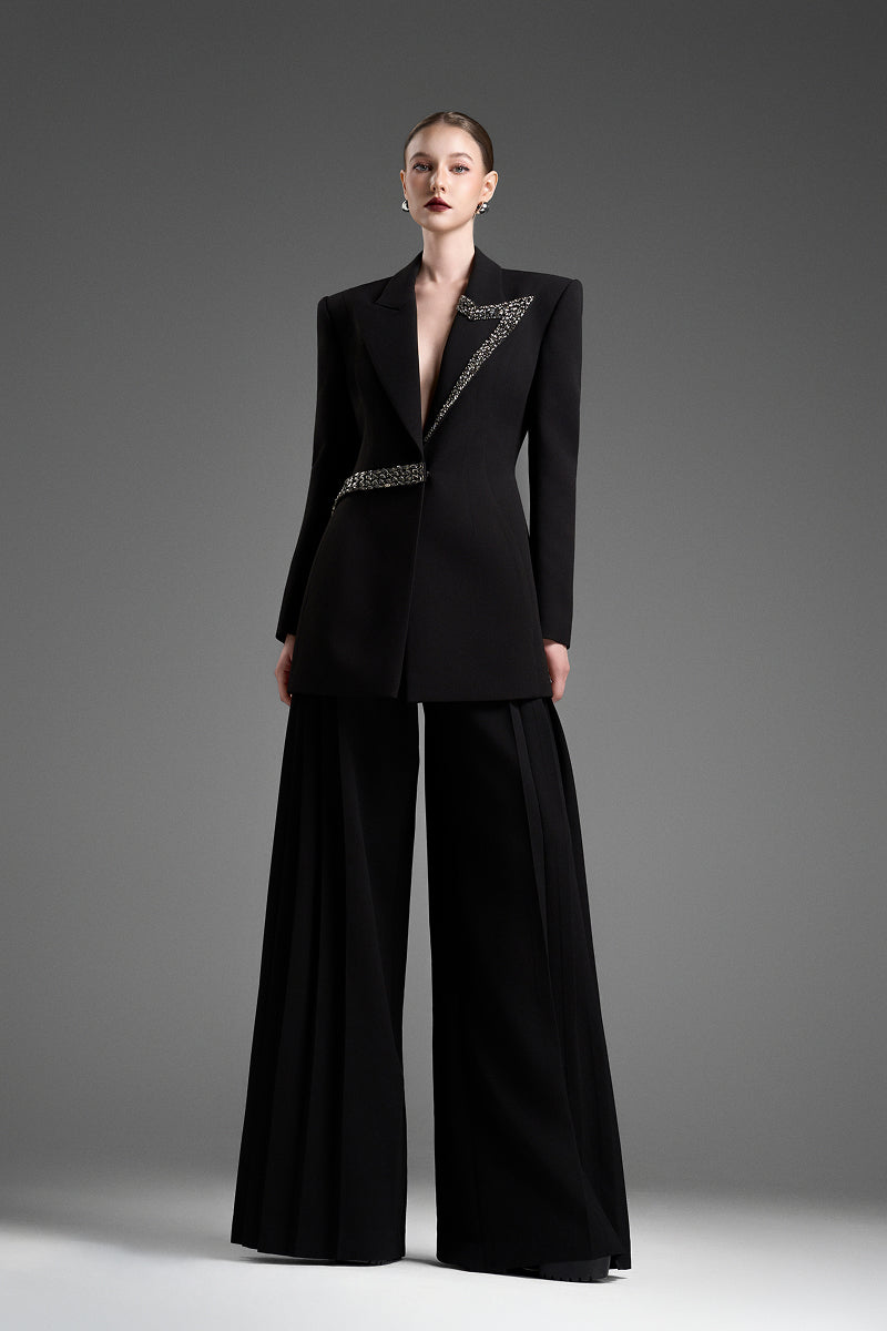 Black tailored blazer with asymmetrical side-tie belt from GVLUX, showcasing a sleek, fitted vest style with stylish detailing.