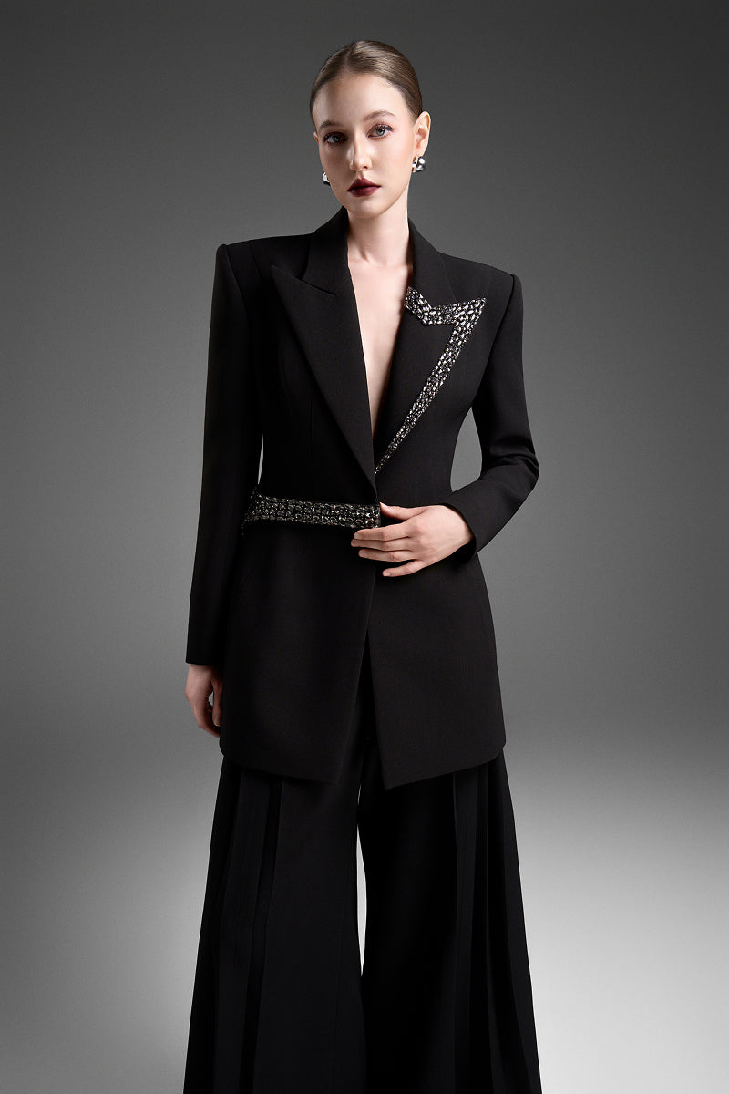 Black tailored blazer vest with an asymmetrical side-tie belt from GVLUX, featuring a sleek and modern design.