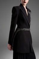 Black tailored blazer vest with asymmetrical side-tie belt by GVLUX, featuring structured fit and modern design.