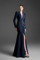 Dark blue V-neck mermaid gown with crystal embellishments by GVLUX, featuring a fitted silhouette and elegant design.