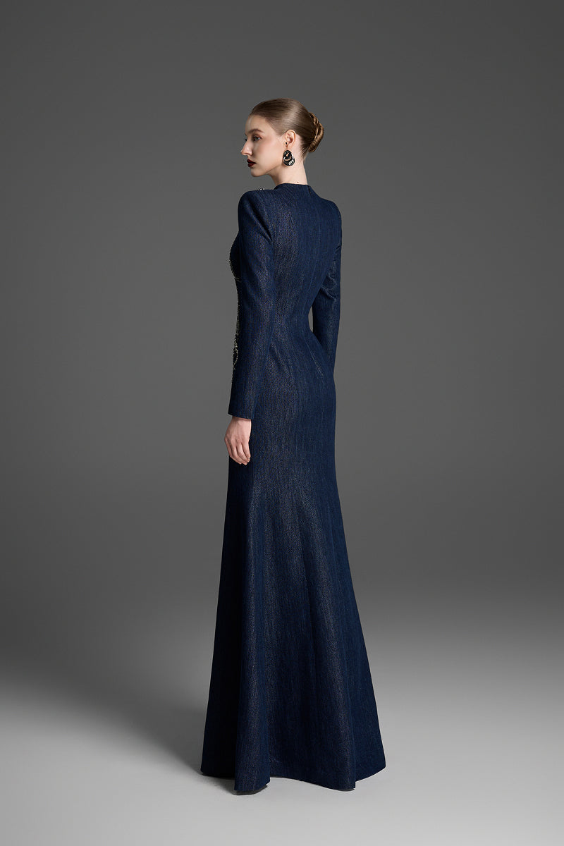 Dark blue V-neck mermaid gown by GVLUX with crystal embellishments, featuring a fitted silhouette and flowing maxi dress style.