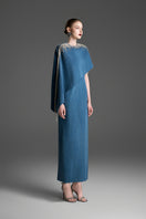 Blue asymmetrical column maxi dress with draped cape sleeve by GVLUX, showcasing elegant fabric and modern design.