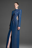 Blue column gown with crystal embroidery by GVLUX, featuring elegant fitted silhouette and intricate beadwork.