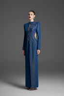 Blue column gown with intricate crystal embroidery by GVLUX, showcasing elegant fabric and detailed embellishments.