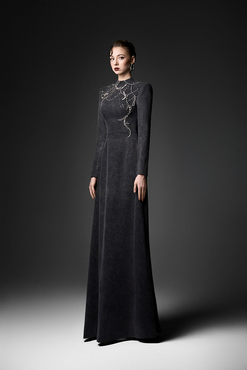 Elegant midnight fireworks long sleeve gown by GVLUX, featuring a flowing silhouette and intricate design for formal occasions.