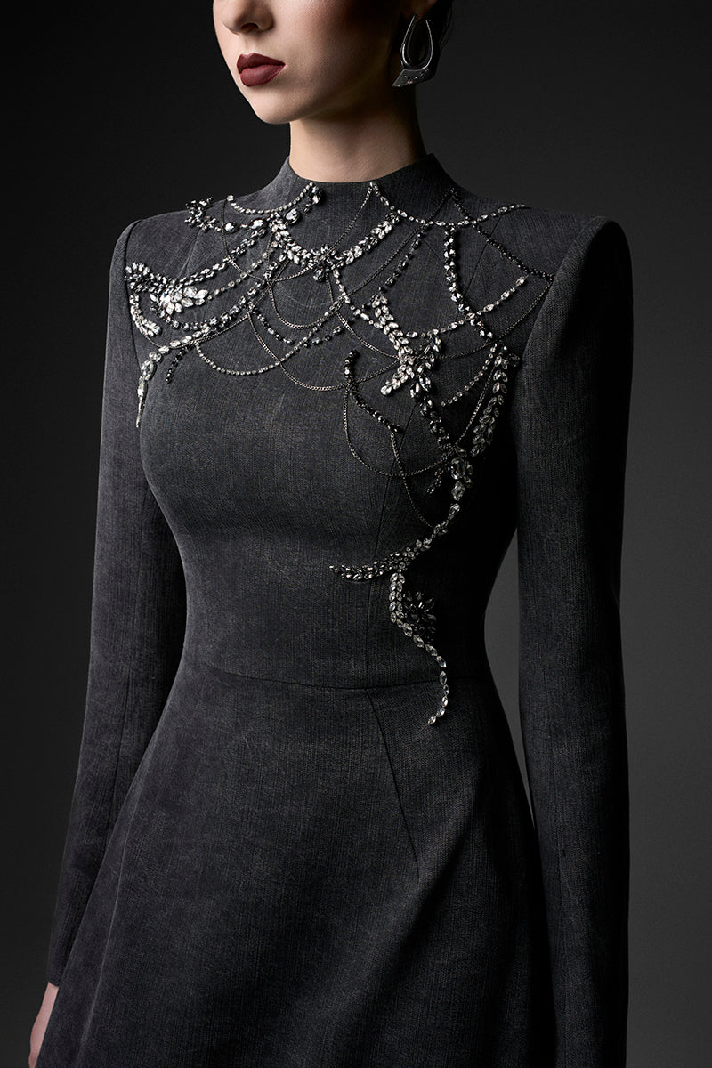 Elegant midnight blue long sleeve gown by GVLUX, featuring a flowing silhouette and intricate detailing, perfect for formal occasions.