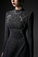 Elegant midnight blue long sleeve gown by GVLUX, featuring a flowing silhouette and intricate detailing, perfect for formal occasions.