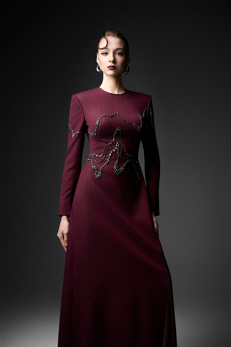 Long sleeve ox embroidered gown by GVLUX, featuring intricate embroidery and flowing fabric, stylish and elegant evening wear.