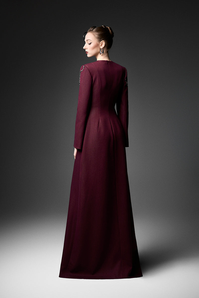 Elegant long sleeve ox embroidered gown by GVLUX featuring intricate embroidery and flowing fabric, perfect for formal occasions.