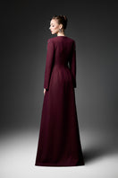 Elegant long sleeve ox embroidered gown by GVLUX featuring intricate embroidery and flowing fabric, perfect for formal occasions.