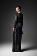 Elegant midnight blue long sleeve gown by GVLUX featuring flowing fabric and intricate detailing, perfect for formal occasions.