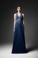Navy embroidered high neck gown by GVLUX featuring intricate embroidery and elegant design, shown on a hanger.