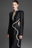 Black sheath gown with wave neckline by GVLUX, featuring a sleek, fitted design and elegant style.