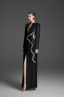Black sheath gown with a wave neckline by GVLUX, featuring a sleek, fitted silhouette and elegant design.