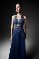Navy high-neck embroidered gown by GVLUX, flowing fabric with intricate embroidery, elegant evening wear for special occasions.