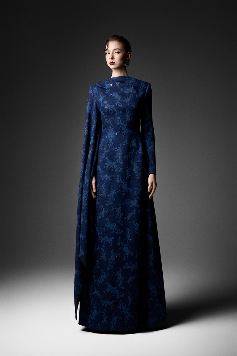 Navy embroidered cape shoulder gown by GVLUX, elegant evening dress with intricate embroidery and flowing fabric.