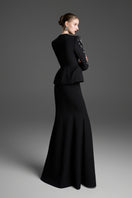 Black paneled construction mermaid maxi skirt by GVLUX, featuring a fitted silhouette with layered panel details.