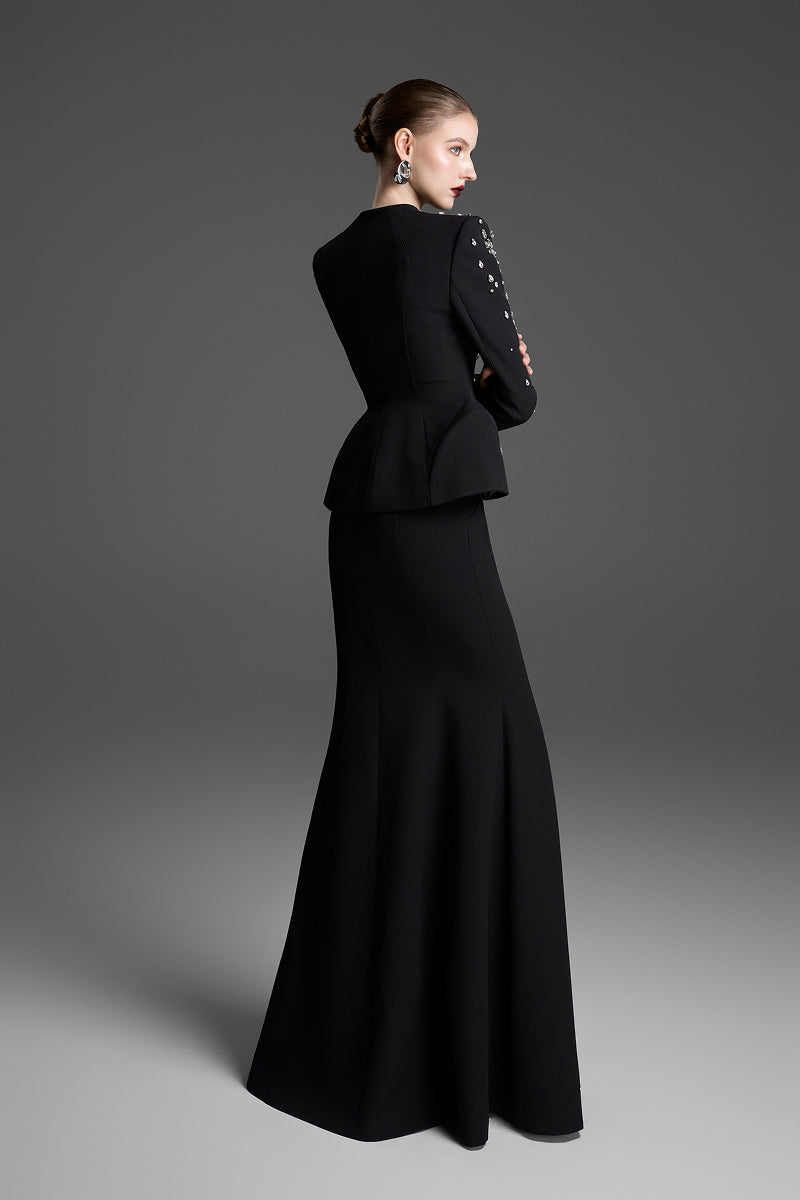 Black collarless paneled vest with curved flared waist by GVLUX, showcasing a stylish, fitted top with unique panel design.