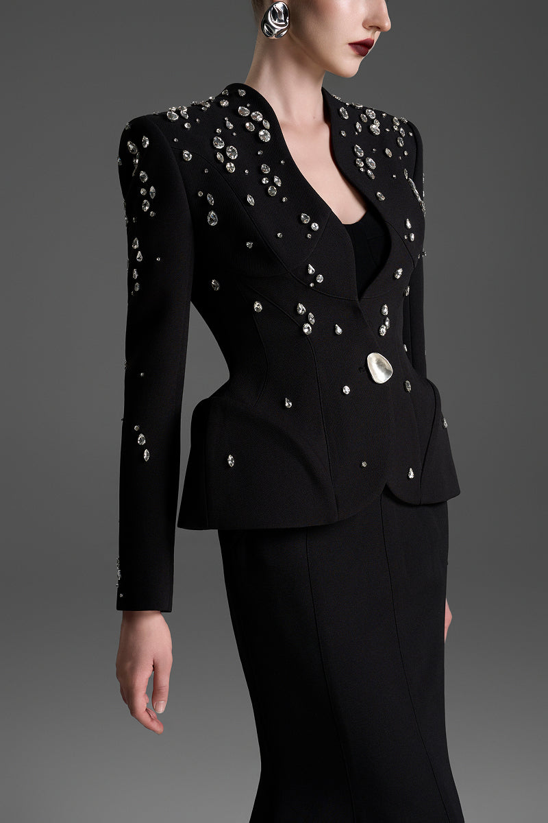Black GVLUX collarless paneled vest with curved flared waist, showcasing a stylish and modern design.