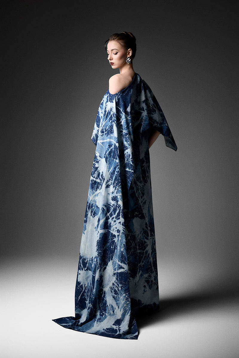 Elegant off-shoulder gown by GVLUX, featuring flowing fabric and stylish design perfect for formal events.