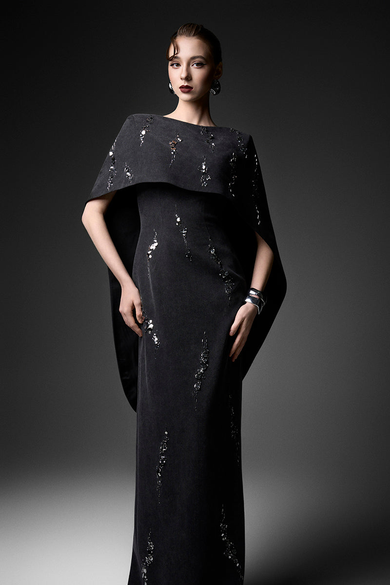 Elegant midnight fireworks cape gown by GVLUX, featuring intricate designs and flowing fabric for formal occasions.