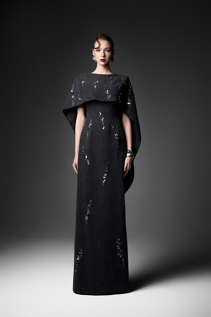 Elegant midnight fireworks cape gown by GVLUX, featuring a flowing design with intricate details suitable for formal events.
