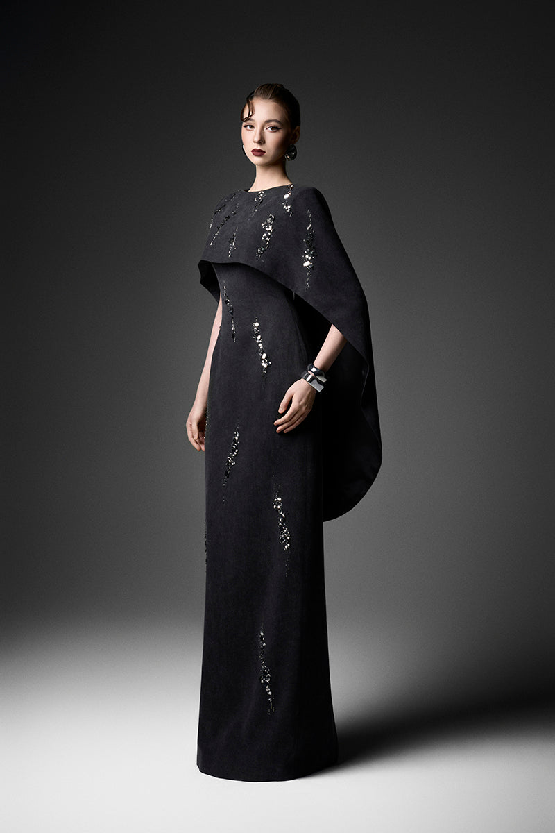 Elegant midnight fireworks cape gown by GVLUX, featuring a flowing design and intricate details for formal occasions.