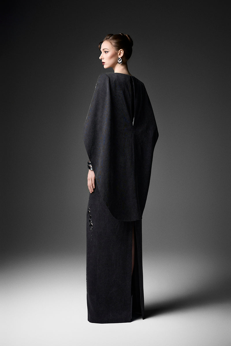 Elegant midnight fireworks cape gown by GVLUX, featuring intricate details and flowing fabric for a glamorous evening look.