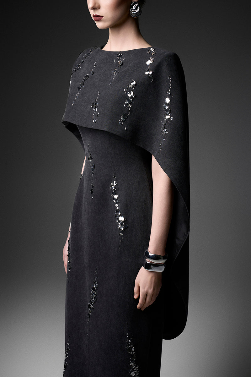 GVLUX Midnight Fireworks Cape Gown featuring a flowing design, intricate detailing, and elegant fabric for formal events.