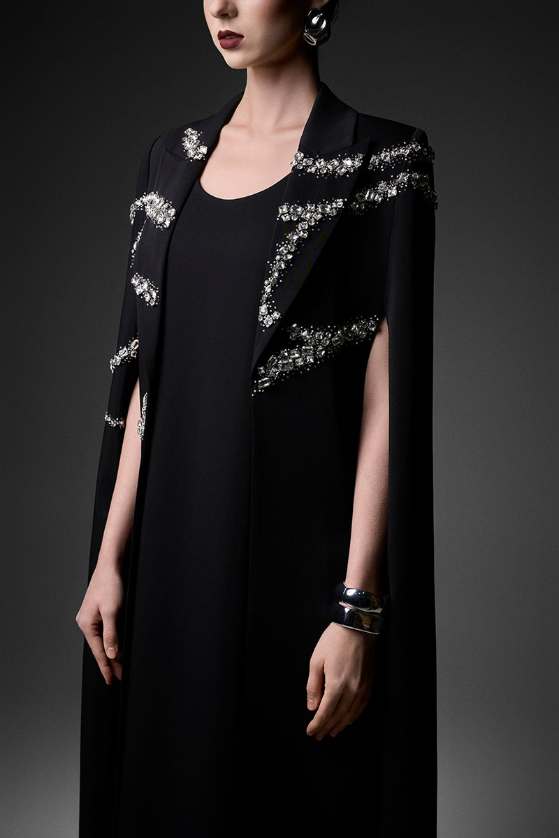 Black embroidered high neck gown with intricate detailing from GVLUX, featuring a flowing silhouette and elegant design.